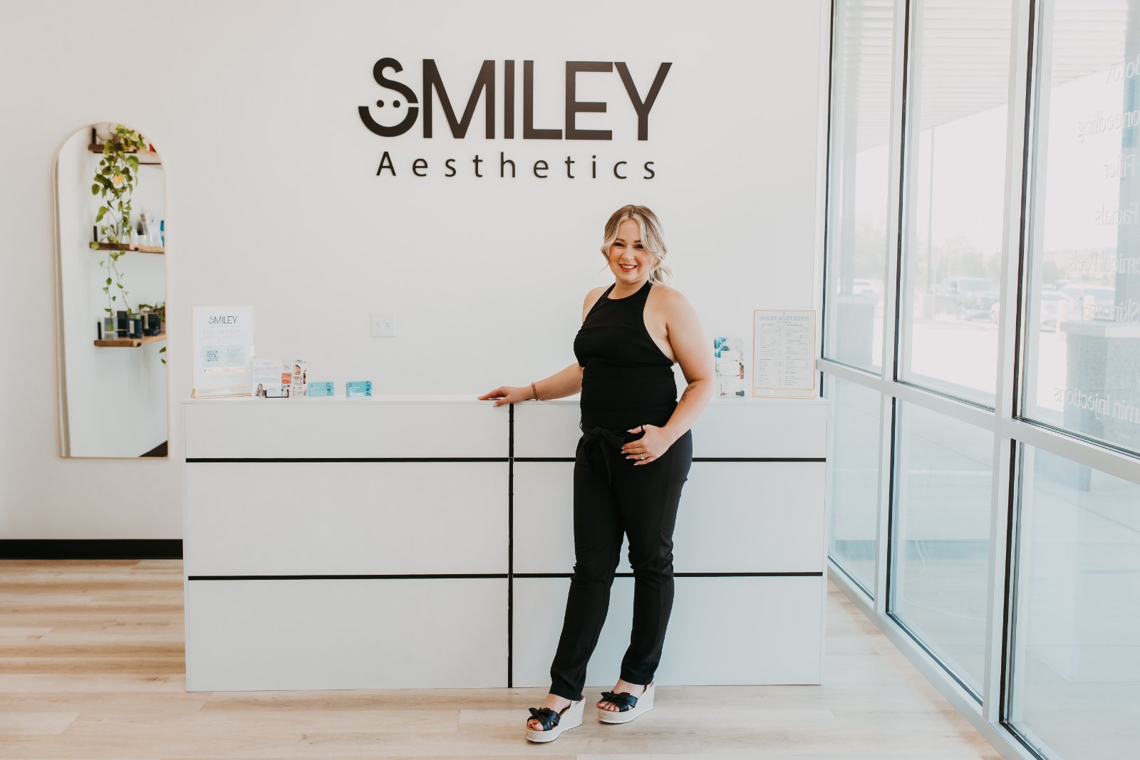 A Smiley Aesthetics team member standing at the front desk in the Soddy-Daisy lobby