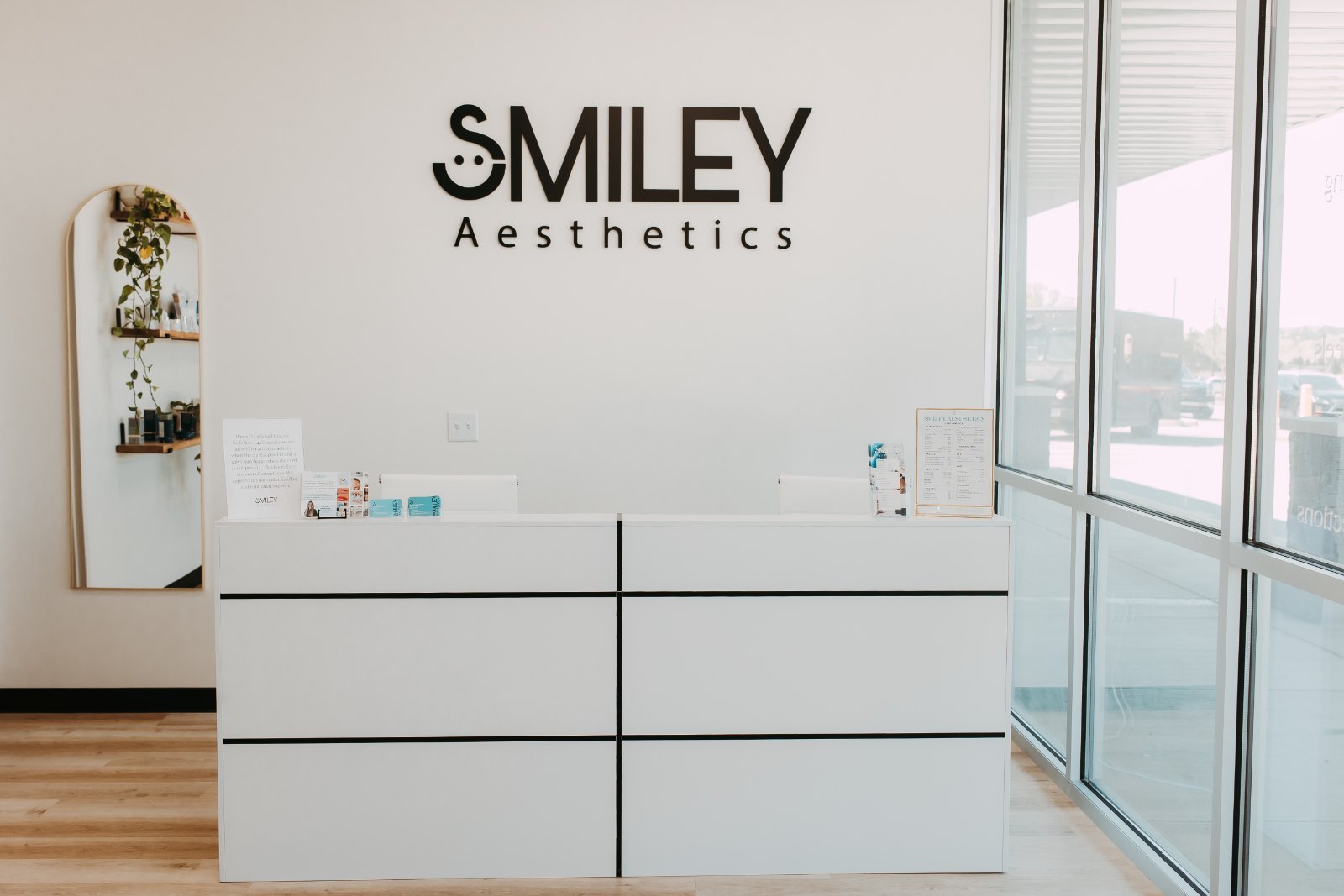 The front desk and lobby of Smiley Aesthetics in Soddy-Daisy with the Smiley Aesthetics sign on the wall